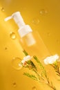 Yellow cosmetic bottle and oil drops Royalty Free Stock Photo