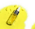 Yellow cosmetic liquid oil in Dropper Bottle place on Potassium Chromate powder