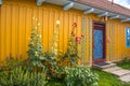 Yellow cottage with hand-painted floral motif in Zalipie, Poland. Painted Village