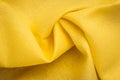 Yellow cotton background of fabric, cage pattern. Linen textile folds, squared texture