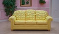 Yellow couch covered in sticky notes in pink room Royalty Free Stock Photo