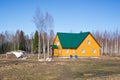 Yellow country house in early spring landscape