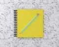 Yellow cover notebook with blue pencil on marble background. Min Royalty Free Stock Photo