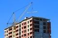 Yellow crane and brick building under construction Royalty Free Stock Photo