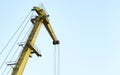 Yellow crane in cargo port translating coal. Industrial scene