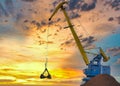 Yellow crane in cargo port translating coal. Industrial scene Royalty Free Stock Photo