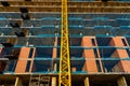 Yellow crane in a construction site to lift large weights of construction material and for the masons to complete their work Royalty Free Stock Photo