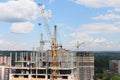 Yellow cranes at construction sites with residential buildings Royalty Free Stock Photo