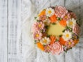 Yellow cream cake decorated with buttercream flowers - peonies, roses, chrysanthemums, scabiosa, carnations - on white wooden back Royalty Free Stock Photo