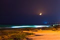 Yellow crescent moon above a stunning beach Royalty Free Stock Photo