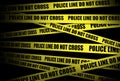 Yellow crime scene tape is seen. Police line do not cross Royalty Free Stock Photo