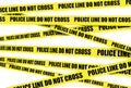 Yellow crime scene tape is seen. Police line do not cross Royalty Free Stock Photo