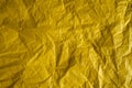 Yellow crinkled wrapping paper with a lot of texture.