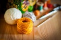 Yellow crochet yarn with hobby tools background on wooden surface Royalty Free Stock Photo