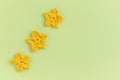 Yellow crocheted flowers row pattern on a green background Royalty Free Stock Photo