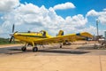 A yellow crop duster plane