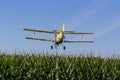 Yellow Crop Duster Spraying Pestisides On Crops Royalty Free Stock Photo