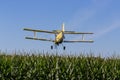 Yellow Crop Duster Spraying Pestisides On Crops