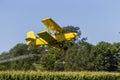 Yellow Crop Duster Spraying Pestisides On Crops Royalty Free Stock Photo