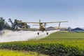 Yellow Crop Duster Spraying Pestisides On Crops