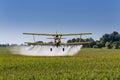 Yellow Crop Duster Spraying Pestisides On Crops