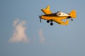 Yellow Crop Dusting Plane Flying in a Blue Sky