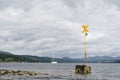 Yellow cross sign on coats to warn ships and boats if shallow water Royalty Free Stock Photo