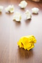 Yellow crumpled paper ball on dark brown wood table with group o Royalty Free Stock Photo