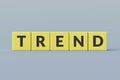 Yellow cubes with word trend on gray background