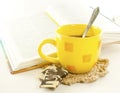 Yellow cup and book Royalty Free Stock Photo
