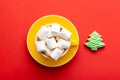 Yellow cup of cappuccino with marshmallows and gingerbread Christmas tree