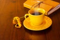 A yellow cup filled with coffee.
