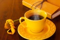 A yellow cup filled with coffee.