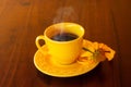 A yellow cup filled with steaming hot coffee. Royalty Free Stock Photo