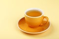 Yellow cup of green oolong tea on saucer Royalty Free Stock Photo