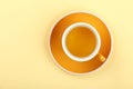 Yellow cup of green oolong tea on saucer Royalty Free Stock Photo