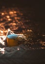 Yellow cup on sweater at sunset.