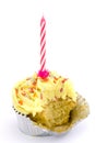 Yellow cupcake with candle and bite taken Royalty Free Stock Photo