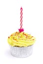 Yellow cupcake with candle over white Royalty Free Stock Photo