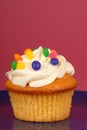 Yellow cupcake with lemon buttercream and candy Royalty Free Stock Photo