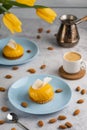 Yellow cupcakes and cup of coffee with yellow tulips on concrete background. Tasty morning dessert Royalty Free Stock Photo