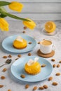 Yellow cupcakes and cup of coffee with yellow tulips on concrete background. Tasty morning dessert Royalty Free Stock Photo