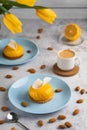 Yellow cupcakes and cup of coffee with yellow tulips on concrete background. Tasty morning dessert Royalty Free Stock Photo