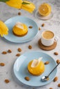 Yellow cupcakes and cup of coffee with yellow tulips on concrete background. Tasty morning dessert Royalty Free Stock Photo