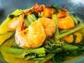 Yellow curry shrimp prawn with morning glory. Traditional local southern food. Delicious sour and spicy soup Royalty Free Stock Photo