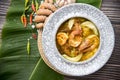 Yellow curry shrimp, thai food and vegetable in white dish / selective focus and top view image,Sour soup made of Tamarind Paste