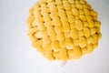 Yellow cushioned chair on a white floor, close up