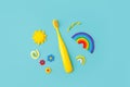 Yellow Cute kids toothbrush, sun, rainbow on blue background. Dental and healthcare concept, copy space, 90s, 80s style design,