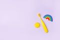 Yellow Cute kids toothbrush, sun, rainbow on pastel purple background. Dental and healthcare concept, copy space, 90s, 80s style Royalty Free Stock Photo