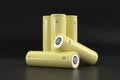 5 yellow cylindrical batteries on a black background. Storage battery or secondary cell. Rechargeable li-ion batteries